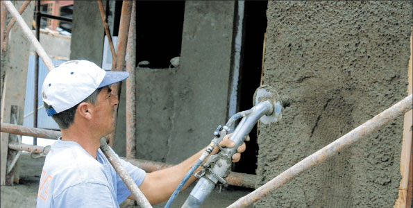 A worker applies plaster on a house in Mavoko. The panel technology can reduce the cost of building a house by upto 20 per cent